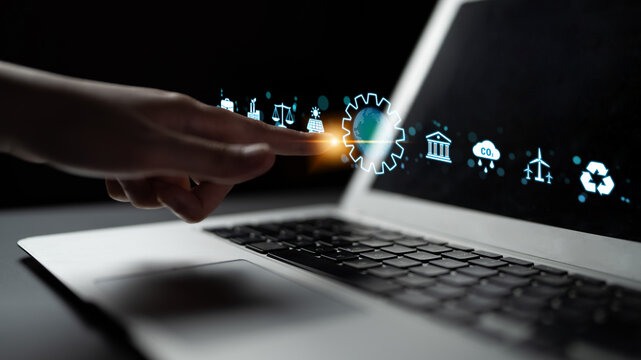 Futuristic Technology Concept with a Hand Interacting with Virtual Interface Icons on a Laptop Keyboard in a Dark Environment. Sentient.