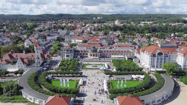 Aerial view of a historic city square with a central fountain, manicured gardens, and surrounding architecture in Gdansk, Pomeranian Voivodeship, Poland.
