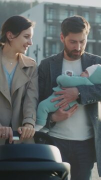 Parents and baby sharing joyful moments by water, Caring family spends quality time outdoors near city riverbank