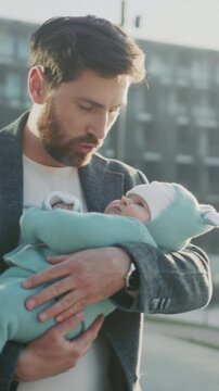 Urban father embraces sleeping baby warmly, Caring father holds infant affectionately in morning light visual