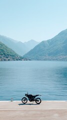 Fototapeta premium Chopper motorcycle resting on a sunny pier by the azure sea, surrounded by breathtaking mountains and clear skies