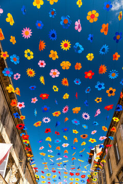 France, Dordogne, Sarlat-la-Can&eacute;da.  Decorative flowers strung above the main road in this market town.