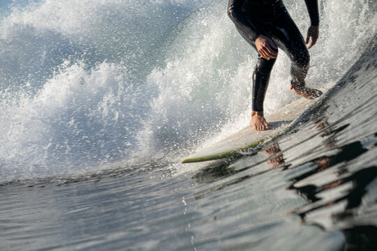 Cropped Surfer Riding Wave Which is Crashing Behind Him
