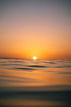 Sunset in the Ocean with Focus Pulled to Foreground