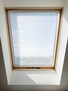 View of a skylight with blinds in a modern indoor space during daylight