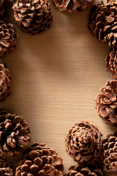 Pine Cone Frame Border Around Wooden Background