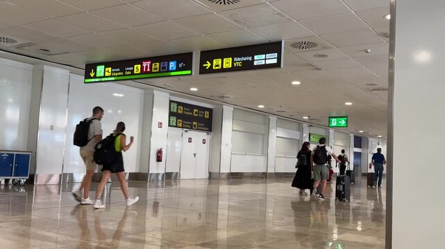 Modern airport terminal interior showcasing a busy passenger transit area