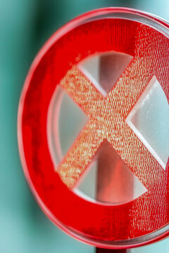 A close-up view of a sign featuring a red 'X' symbol, great for use as a warning or caution indicator. vertical frame
