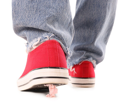Woman stepping into chewing gum on white background, closeup. Stickiness concept