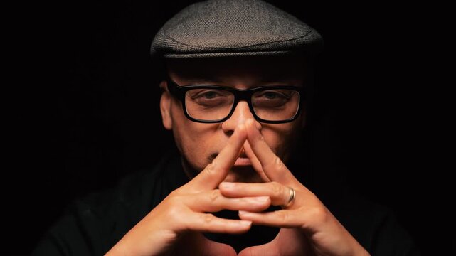 Black man fingers cover face
