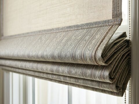 Close view of rolled fabric window treatment in a well-lit indoor space during the daytime