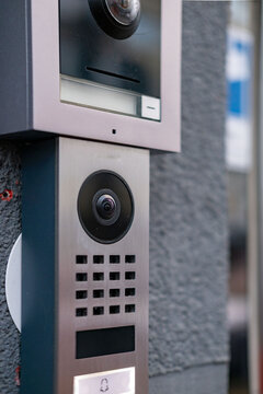Video intercom with camera and speaker on wall, security access control terminal, door entry system, building entrance technology, Smart technology surveillance equipment, modern intercom device