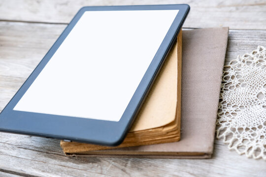 ebook reader on stack old paper books on wooden table, electronic book, digital reading device and vintage literature contrast, technology vs tradition, Back to school and education, blank copy space