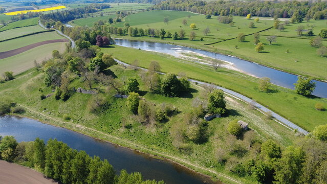 Aerial view of Roxburgh Castle ruins surrounded at the confluence of the Teviot and Tweed rivers, Kelso, Scottish Borders, Scotland, UK