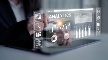 Business professional working with futuristic analytics dashboard on tablet displaying data...