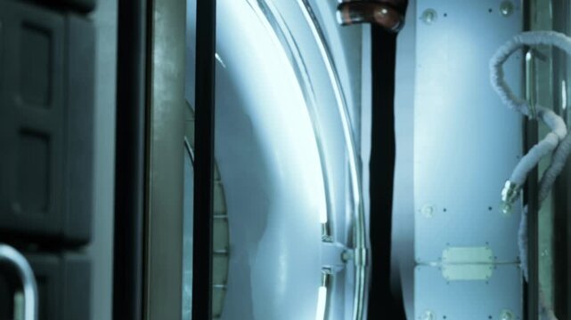 Inside a high tech facility, sleek storage units line the walls, creating a futuristic atmosphere. Soft, glowing lights illuminate the space, highlighting its modern design and functionality.