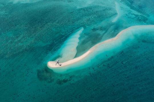 Seen from a bird's eye view, low tide exposes a scenic, sandy island amid the Derawan Archipelago of East Kalimantan, Indonesia. This beautiful area is a popular vacation destination.