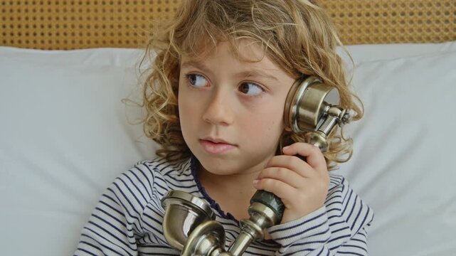 small girl speaking on a vintage telephone