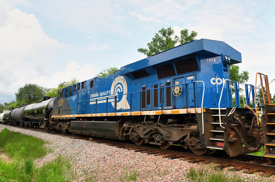 A CSX Transportation heritage locomotive honoring the former Conrail, helps lead a Canadian Pacific Kansas City freight train through northeastern Illinois bound for Iowa.