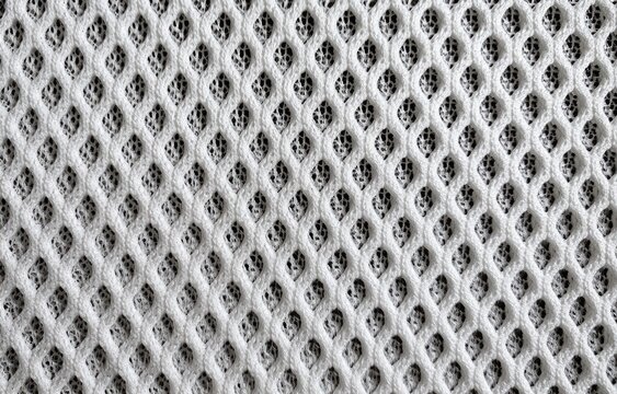 Close-up of a white, woven mesh fabric with a repeating hexagonal pattern