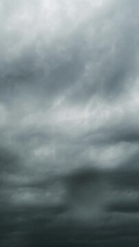 Vertical time lapse of grey stormy clouds with raindrops