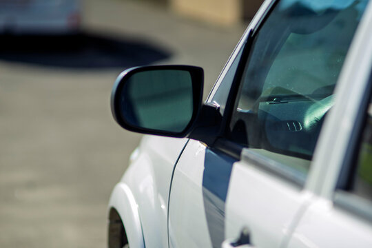 White modern car side view mirror close up detail