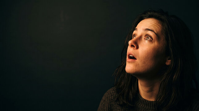 Woman's face showing shock and disbelief as she looks upwards