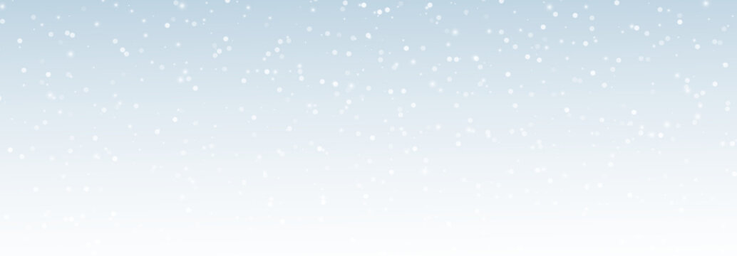Elegant snowfall with white snow-covered snowflakes, sparkling ice crystals and soft blurry particles on a winter background, the edge disappears into a calm empty space for seasonal design use.