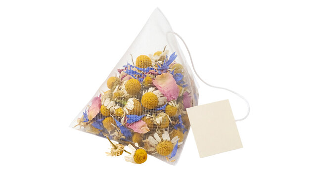 Pyramid tea bag with chamomile and floral herbs, premium silk mesh sachet with loose leaf botanicals, organic herbal infusion isolated PNG with Transparent Background