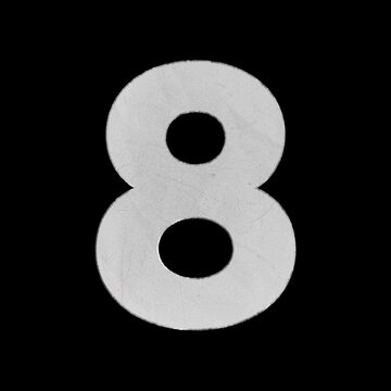 White crumpled paper cutout of the number eight isolated on a black background
