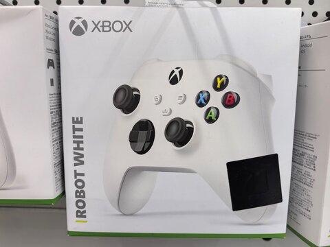 New xbox controller packaged in crisp white design on store shelf