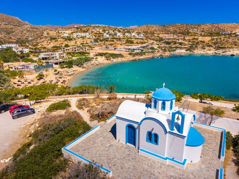 View of sea bay with beautiful beach and traditional church on Karpathos island in Ammopi village, Greece