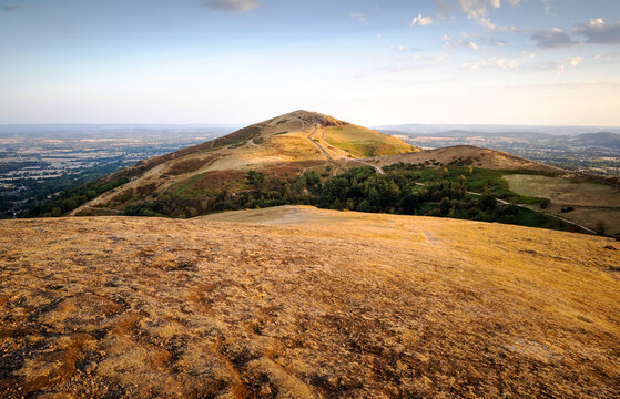 View of sun baked Worcestershire Beacon at sunset,atop the Malvern Hills,Worcestershire,England,UK.