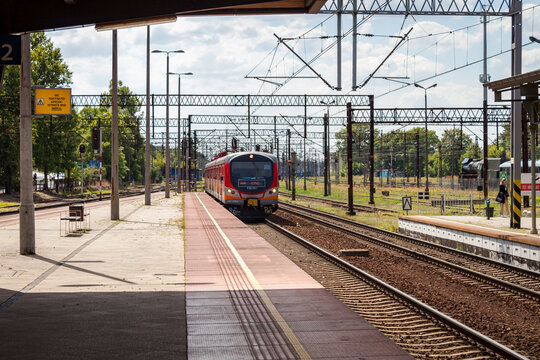 Red regional passenger train arriving at Bydgoszcz Gł&oacute;wna station platform in Bydgoszcz, Poland