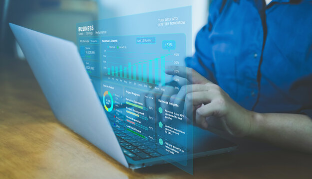 Businessman using laptop with holographic digital business growth chart and performance dashboard