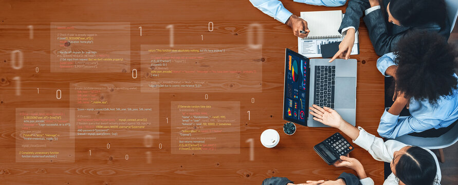 A diverse team collaborates in a modern office setting, analyzing data and coding on a laptop while discussing insights with charts and graphs. Trope