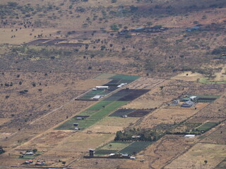 Obraz premium Aerial View of Agricultural Farmland Plots and Greenhouses in Rural Landscape Ngong Hills Kenya