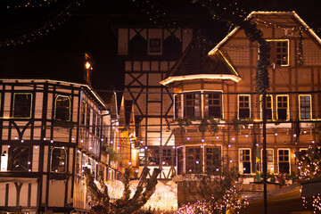 Traditional Half Timbered Buildings Illuminated with Festive Fairy Lights at Night © Nicolas GR
