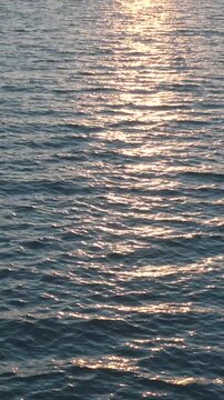 Golden Sun Reflection on Calm Sea Surface