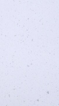 Falling snowflakes on dark winter background