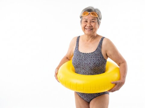 Joyful Elderly Asian Woman in Swimsuit with Goggles and Yellow Float Ready for Swimming Fun Isolated on White Background