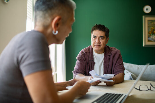 Mature couple reviewing household bills at home