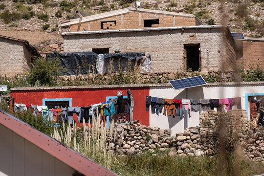 Barrio de casas de adobe en construcci&oacute;n con ropa tendida pobreza humildad