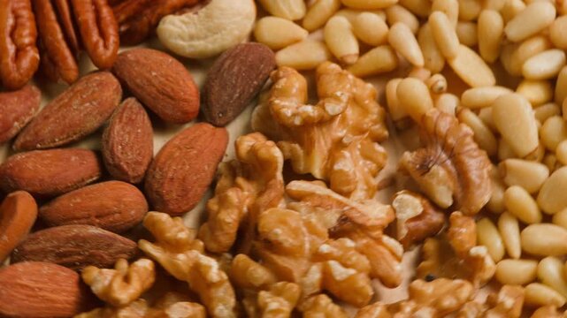 Nuts mix of pecan walnut cashew hazelnut pine and Brazil nuts with peanut on wooden table healthy snack close-up