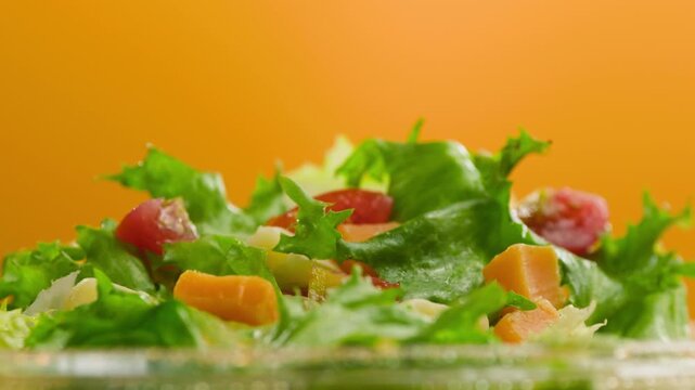 Olive, Sunflower, Avocado, Sesame, Coconut, Flaxseed Oil Pouring Over Fresh Green Caesar Salad Leaves in Bowl, Close Up of Healthy Organic Food Preparation, Restaurant and Cafe Cooking Concept