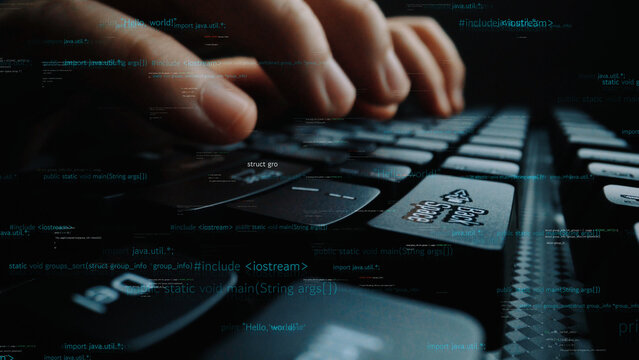A close-up view of hands actively typing on a keyboard, surrounded by coding text, illustrating themes of technology, programming, and software development. Xenic