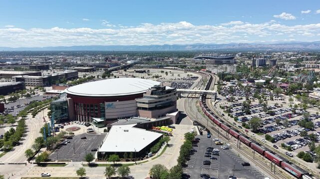 Sports arena next to downtown Denver with the Rocky Mountains in the distance in Colorado. 