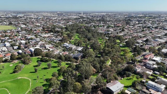 Aerial view of green space and linear park along Stony Creek, winding through suburban residential neighborhood of Yarraville. Ecological links, drainage integration in Melbourne, Victoria, Australia