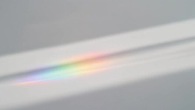 Abstract background with soft light beam and prismatic rainbow color reflection on white surface
