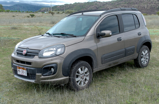 ZAPOPAN, MEXICO - AUGUST 5, 2026: Brown Fiat Uno Way parked on open rural land.